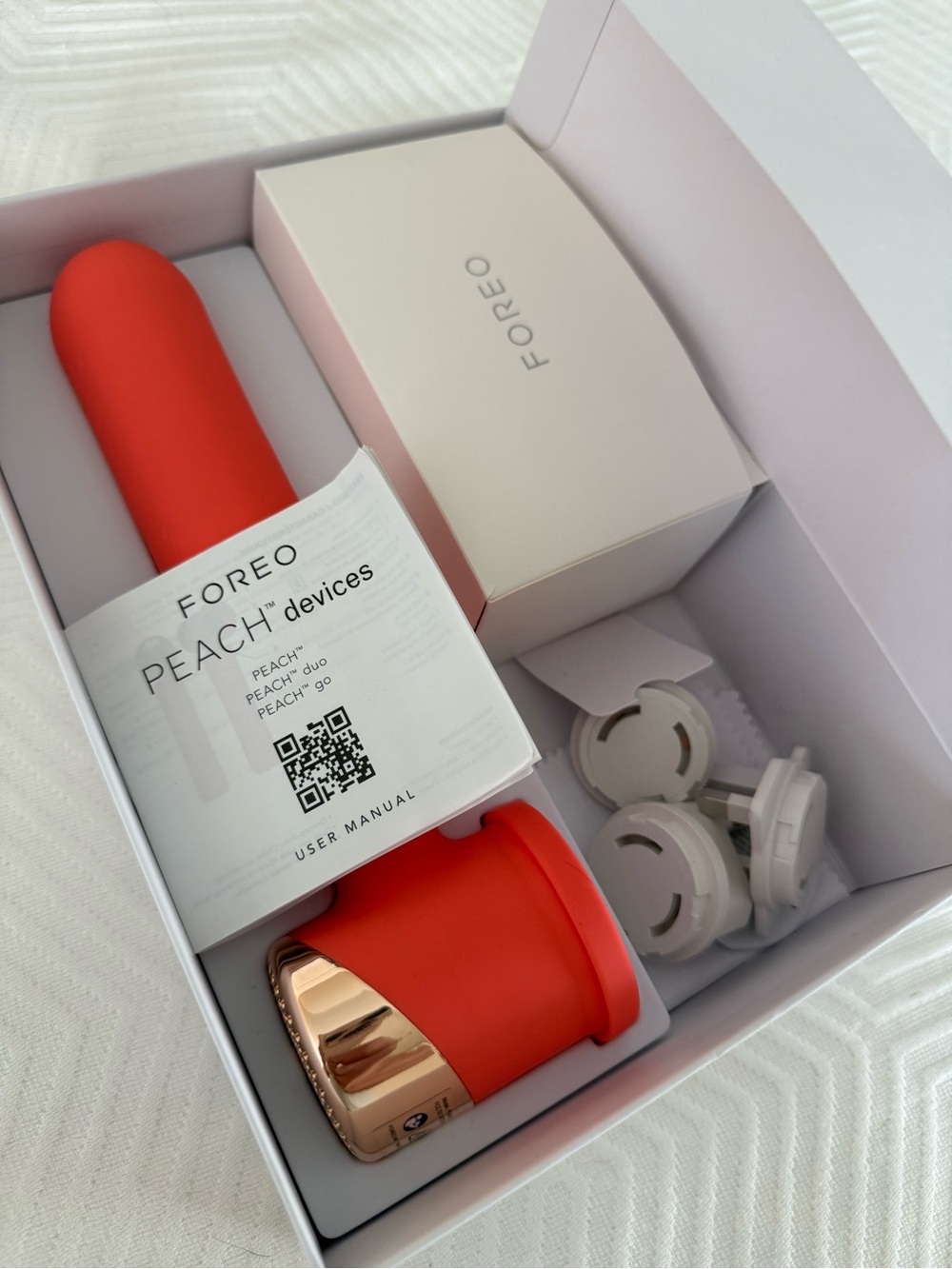 FOREO Peach Silicone Facial Massager in Vibrant Coral